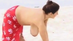 Huge boobs stretches on beach